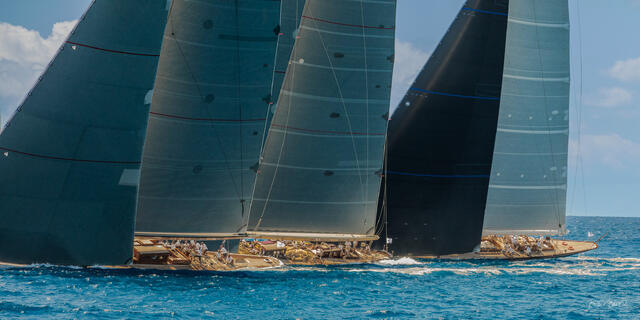Two J Class sailing yachts racing side by side across the turquoise waters of St. Barths