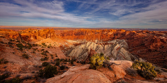 Panoramic view of a striped, crater-like canyon landscape ay Upheaval Dome in Capitol Reef National Park, Utah