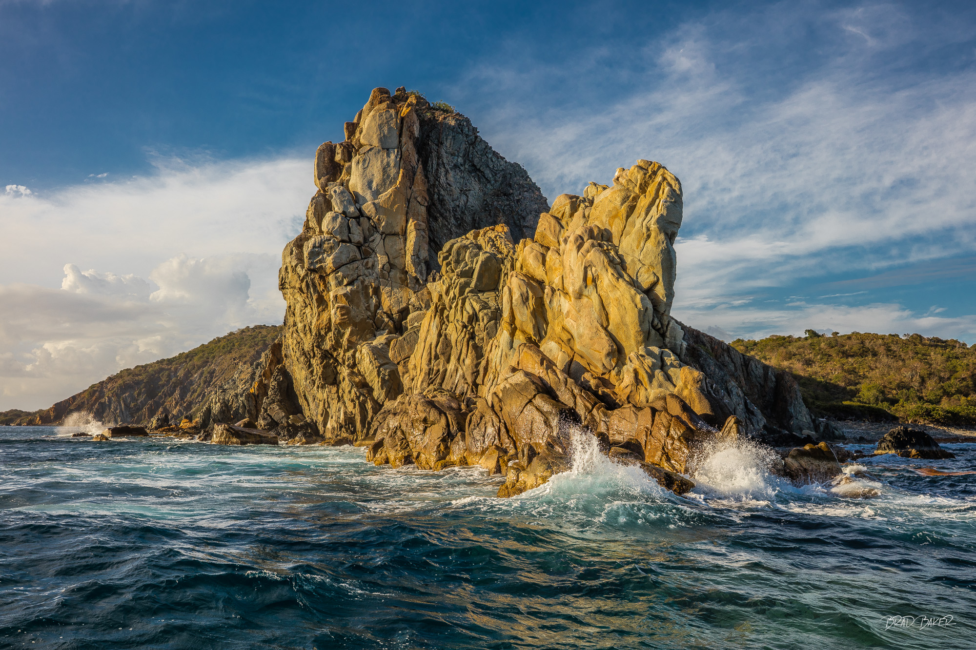 COOPER ISLAND CORNER Dramatic rocky outcrop battered by Atlantic waves glowing in warm late afternoon light, Cooper Island BVI.