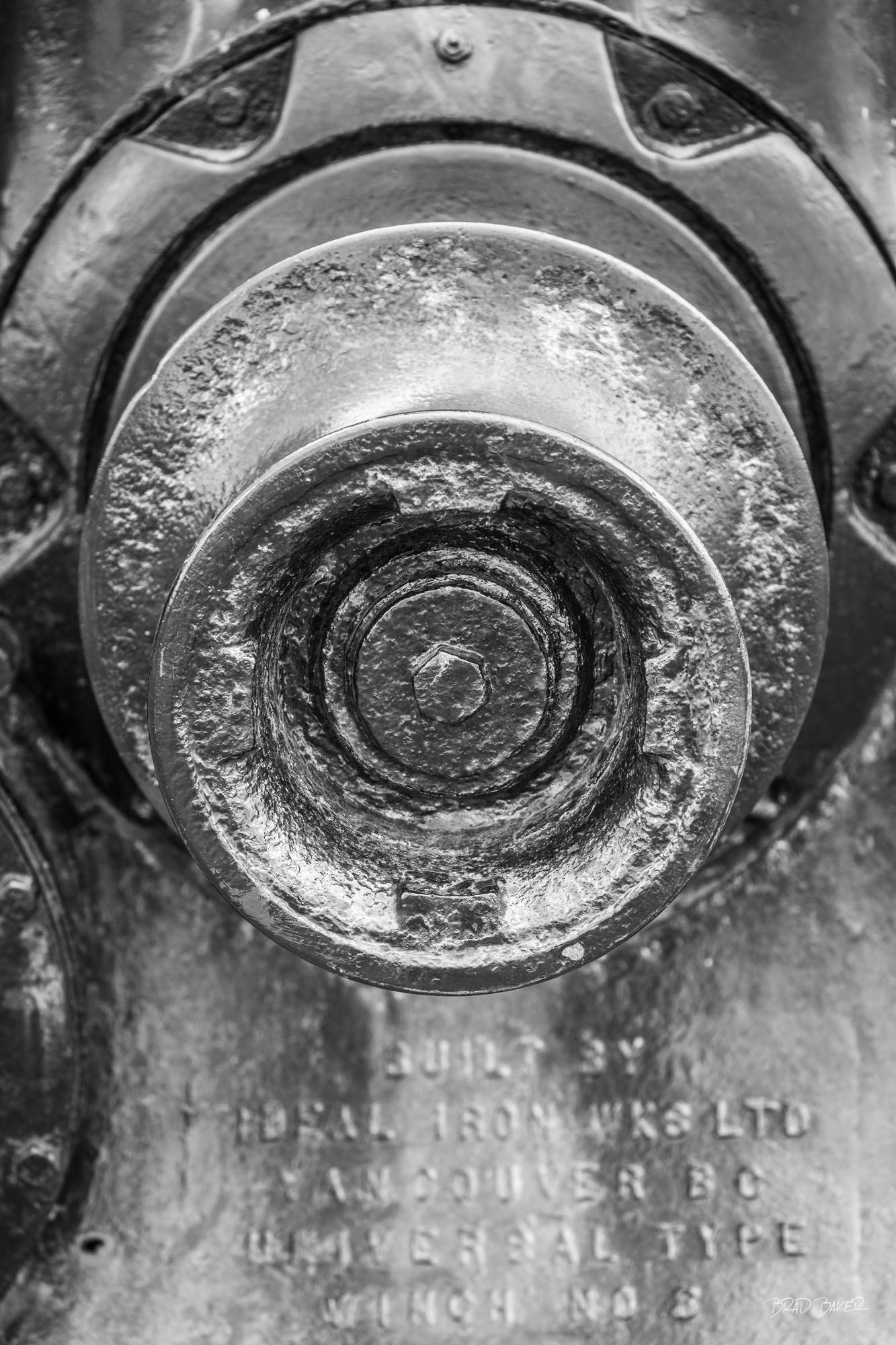 WELL WORN CAPSTAN Extreme macro black and white detail of weathered iron capstan winch, built by Dominion Iron Works Vancouver BC