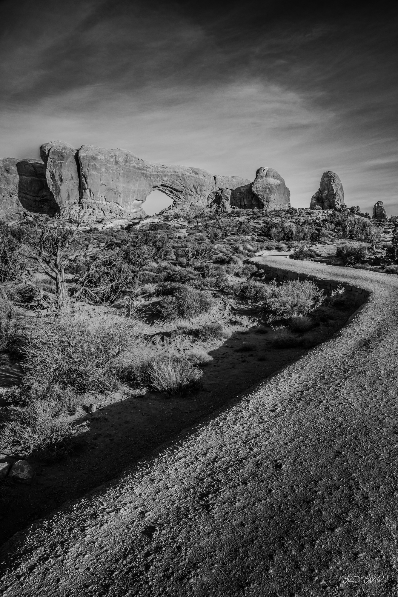 Passage to the Portal Towering sandstone fins rising above a desert canyon trail in Arches National Park, Utah