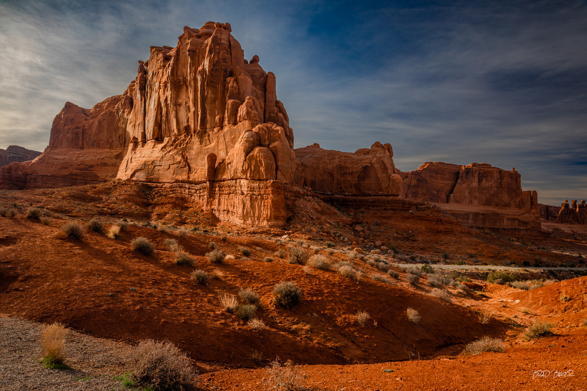 The Judge Massive sandstone monolith glowing orange against a deep blue sky in Arches National Park
