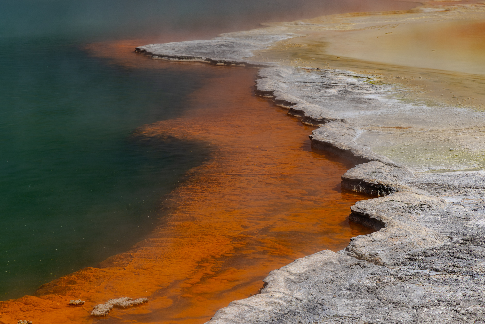 Layers at Champagne pool Vibrant teal and orange geothermal pool with silica terraces at Wai-O-Tapu, New Zealand