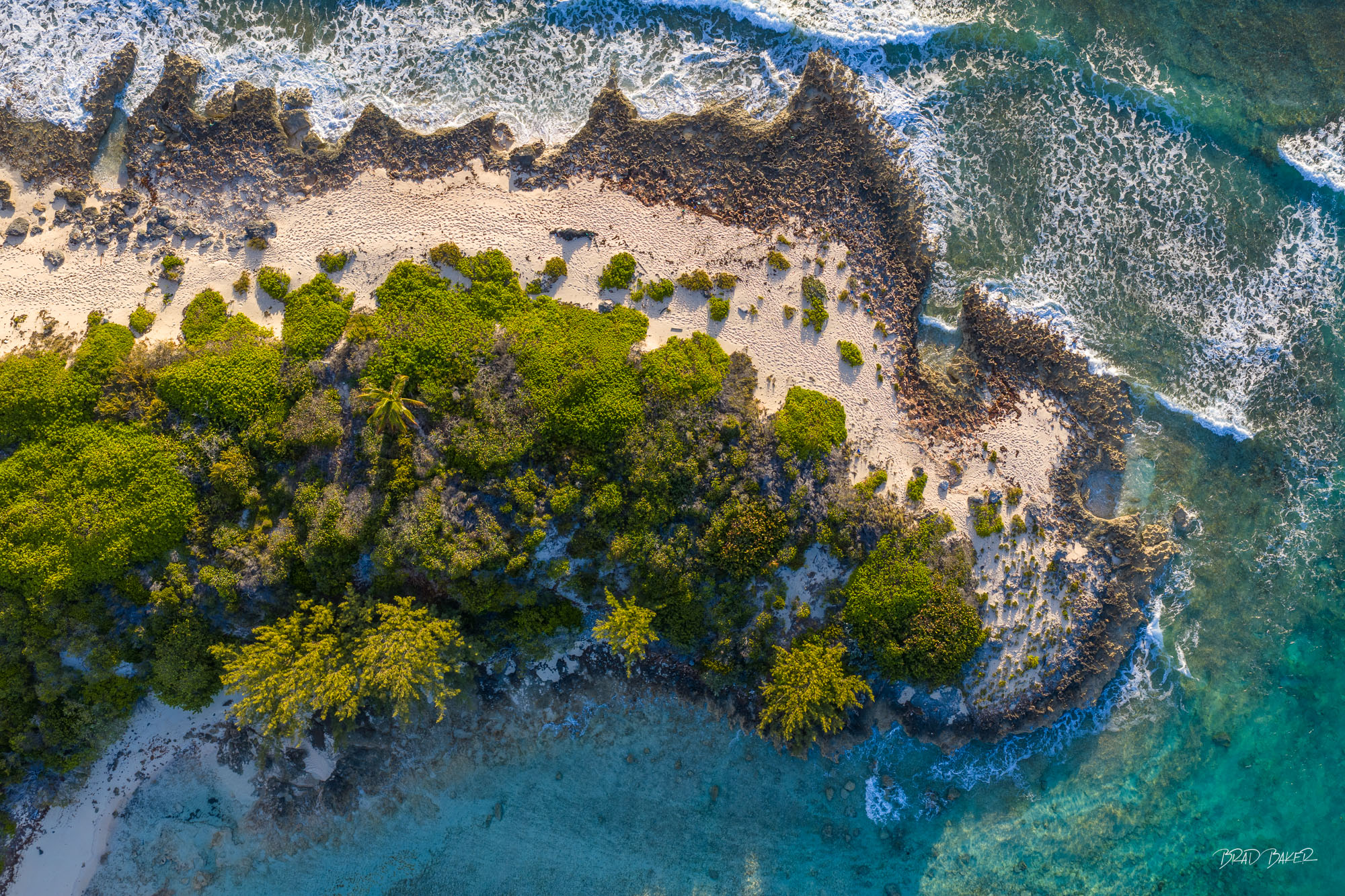 RUGGED ISLAND SHORES Aerial view of a jagged coral island coastline battered by waves under soft morning golden light in The Bahamas